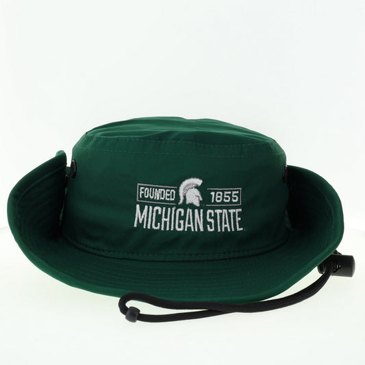 A green bucket hat with white embroidered text 'Michigan State' and "Founded 1855' with the Spartan helmet logo, featuring a drawstring chinstrap, and snap buttons on the side.