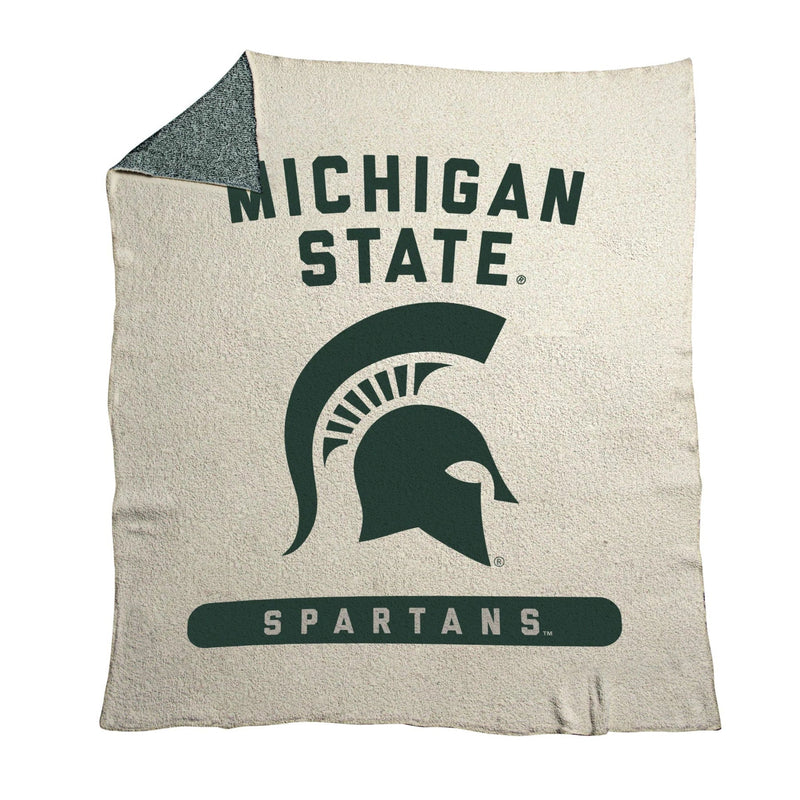 A white blanket with a green design reading "Michigan State Spartans" around a Spartan helmet logo.