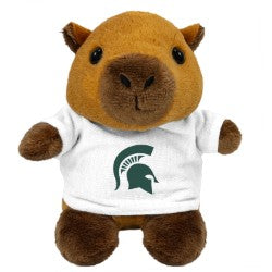 Small plush capybara toy wearing a white T-shirt featuring the green Michigan State Spartan helmet logo on the front. The stuffed animal has a tan and white body, brown hooves, a short mane, and embroidered facial details. Product shown against a light gray background.