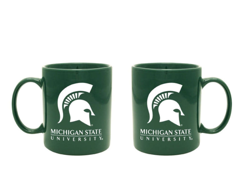 Two green with white mugs with the Michigan State University wordmark on the side.