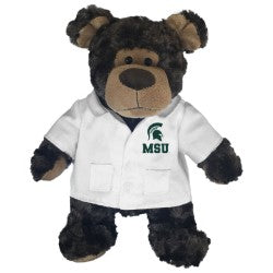 Dark brown bear wearing a white doctors coat. On doctors coat on left chest is a green Spartan helmet logo with MSU in green under helmet. 