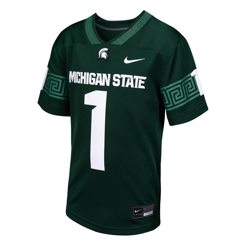A green football jersey with white text reading "Michigan State" and the number 1 below. Above the text are a white Spartan helmet logo and a white Nike swoosh. The sleeves and collar are accented with a light green "Greek" pattern.