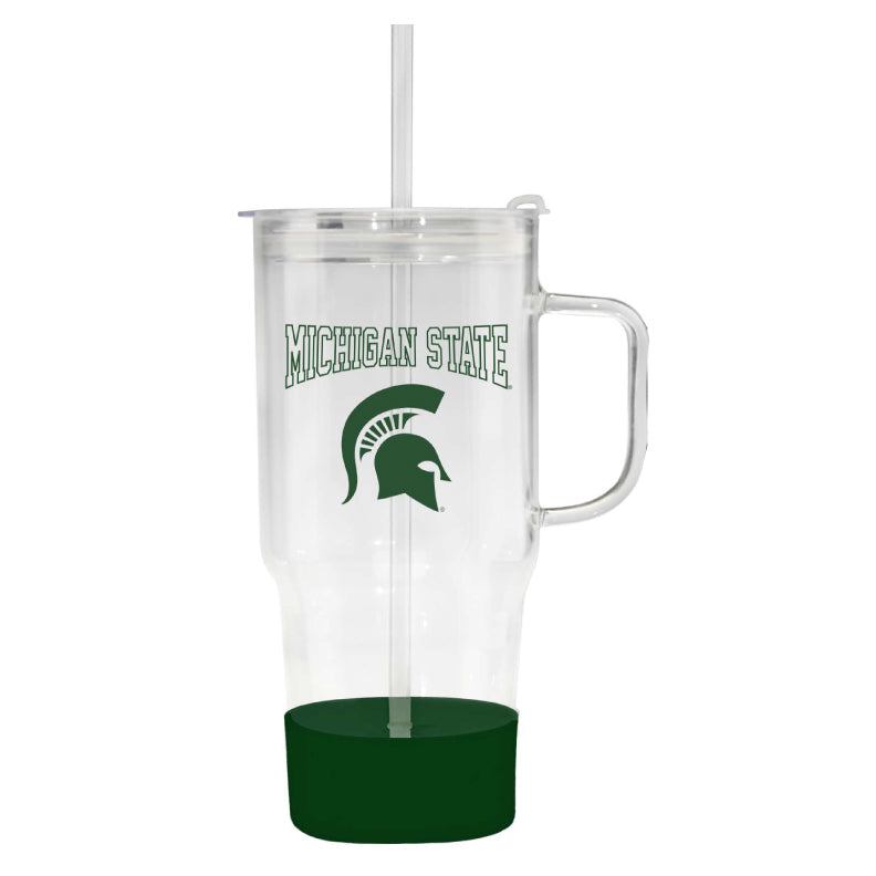 Clear plastic Michigan State University travel tumbler with a handle, matching lid, and reusable straw. The tumbler features green “MICHIGAN STATE” lettering above the Spartan helmet logo on the front, with a dark green accent base at the bottom. Product shown against a light gray background.