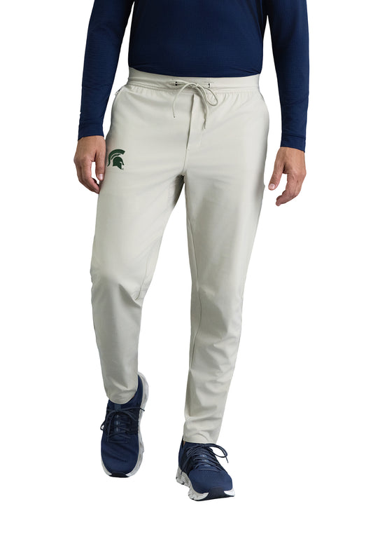 Stone color elastic waistband with drawstring. Slim fit pant with green embroidered Spartan helmet on left hip. 