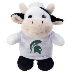 Small plush cow toy wearing a white T-shirt featuring the green Michigan State Spartan helmet logo on the front. The stuffed animal has a tan and white body, brown hooves, a short mane, and embroidered facial details. Product shown against a light gray background.