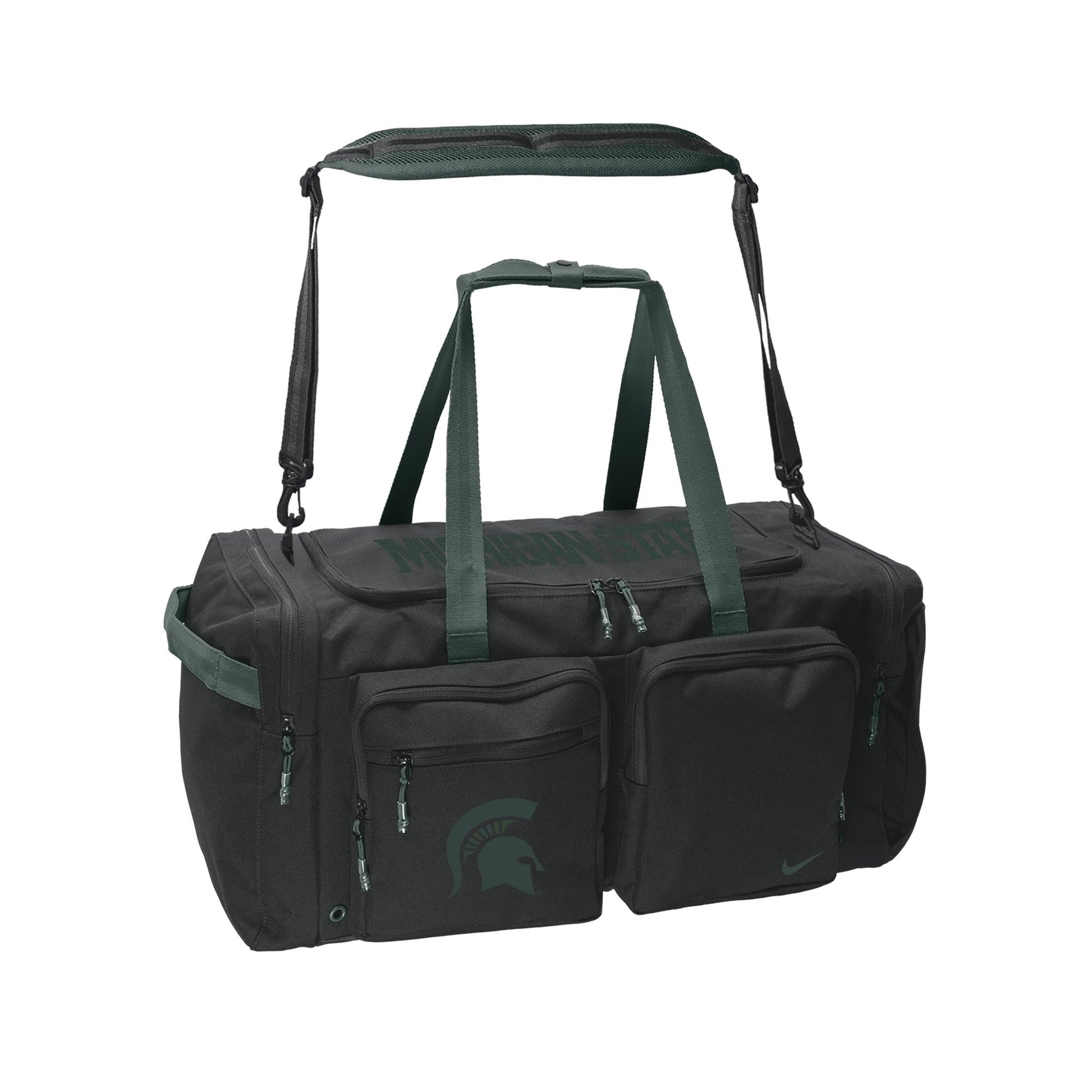 Black Nike duffel bag with dark green carrying handles and a removable padded shoulder strap. The front features multiple zippered pockets, including one with the Michigan State Spartans helmet logo, while subtle "Michigan State" lettering appears across the top.