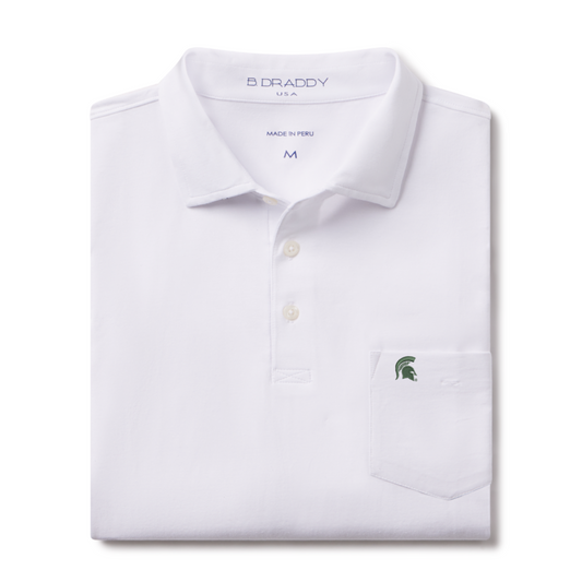 Folded white polo shirt with a collar and three-button placket, featuring a chest pocket with an embroidered green Spartan helmet logo and 'B DRADDY USA' branding inside the collar.
