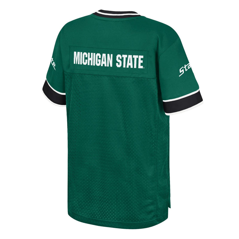 Back view of a green sports jersey with 'MICHIGAN STATE' in white capital letters across the upper back, black and white striped sleeves, and 'State' written on the left sleeve.