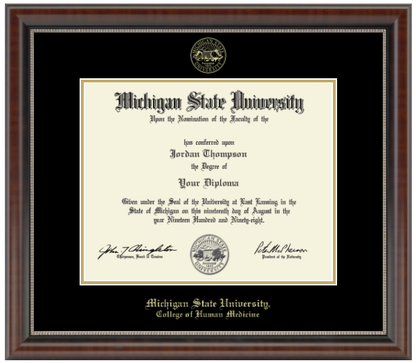 The diploma is enclosed in a dark brown wood frame with a black matte and gold trim. "Michigan State University" is printed in gold lettering at the bottom center of the frame. Below in gold letters, "College of Human Medicine."