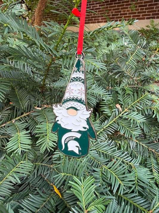 Decorative green and white gnome ornament. The gnome has a green and white hat with festive designs on it. The gnome's green sweater has a white Spartan helmet logo on the front.  