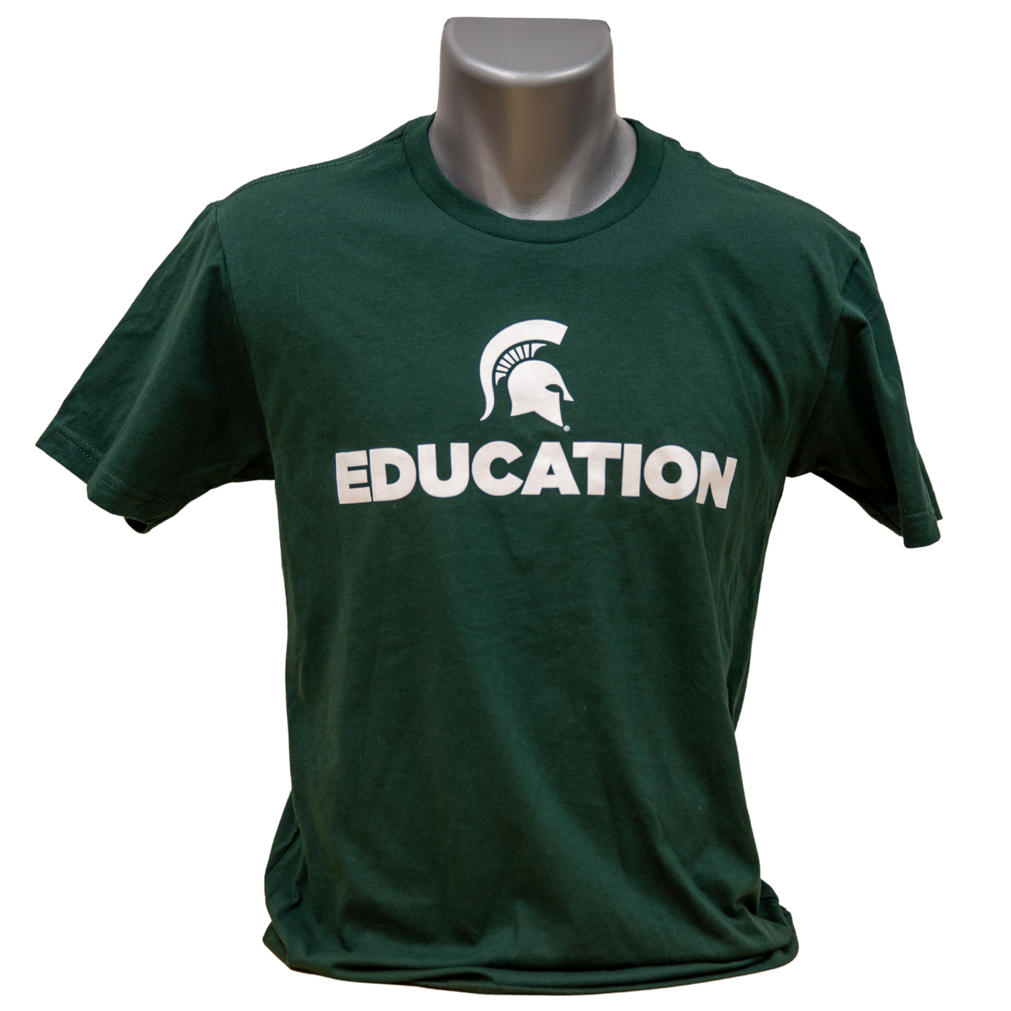 Forest green short-sleeve women's crewneck T-shirt with a white Spartan Helmet logo above text reading "Education" in all caps. Shown on a mannequin. 