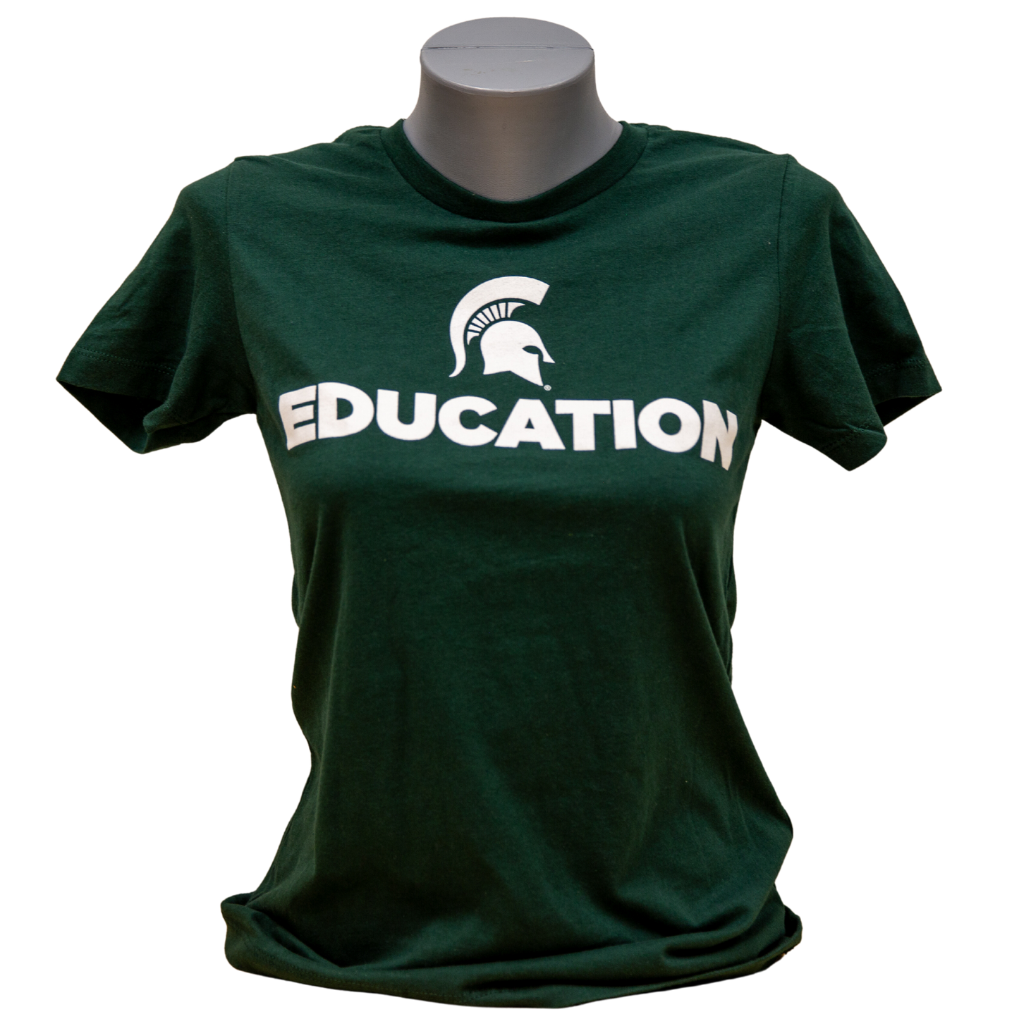 Forest green short-sleeve women's crewneck T-shirt with a white Spartan Helmet logo above text reading "Education" in all caps. Shown on a mannequin. 
