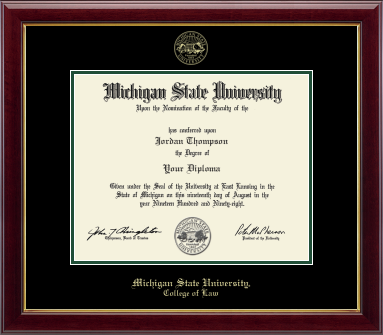 The diploma is set in a dark red wood frame with black matting with tartan green accents, and includes the university seal and signatures. "Michigan State University, College of Law" is printed at the bottom.