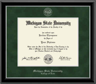 The diploma is enclosed in a dark wood frame with a green suede matte and silver trim, and includes signatures from university officials. Top of matting silver embossed Michigan State University seal. Bottom of frame in silver cursive letters is 'Michigan State University'. Below in silver and cursive letters is 'College of Law'. 