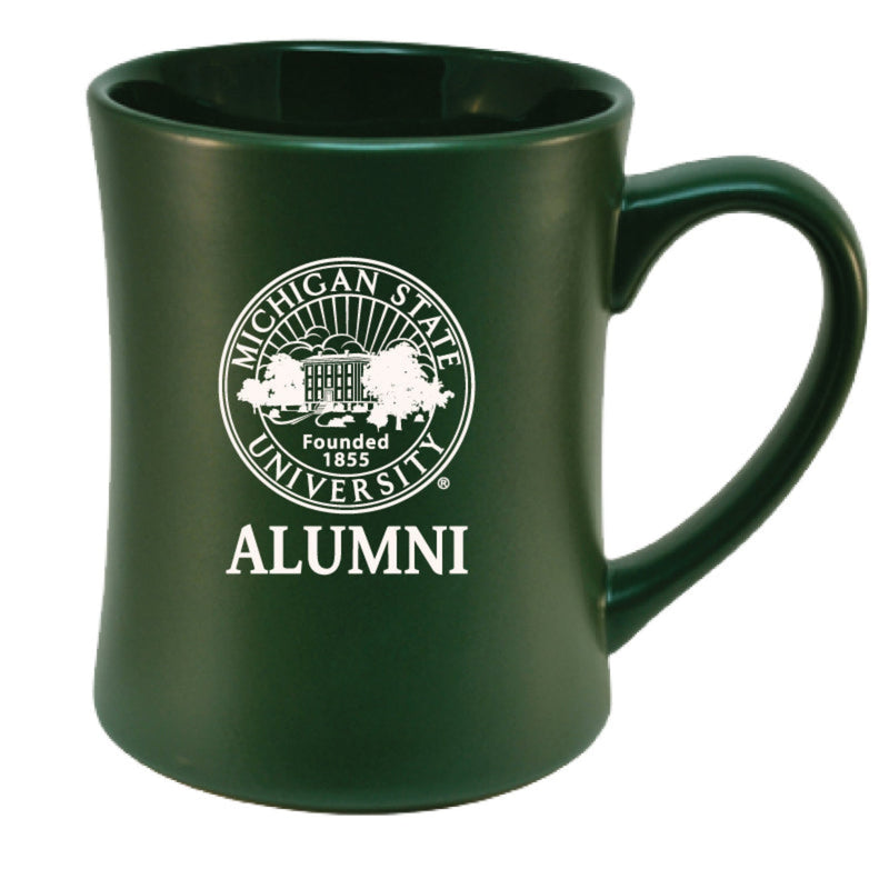 Green ceramic mug featuring the Michigan State University seal and the word 'ALUMNI' printed below, both in white. 