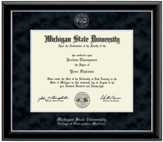 Framed Michigan State University diploma in a black glossy frame with a silver inner edge. The matte is black, featuring the university seal at the top center and 'Michigan State University College of Osteopathic Medicine' written in silver at the bottom center.