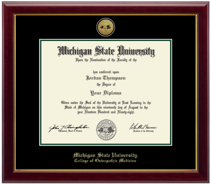 Framed Michigan State University diploma in a dark wood frame with a gold inner edge. The matte is black with a green inner border surrounding the diploma. Michigan State seal is at the top of matte and is gold engraved. "Michigan State University" is inscribed in gold at the bottom of the frame. Below Michigan State University is "College of Osteopathic Medicine."