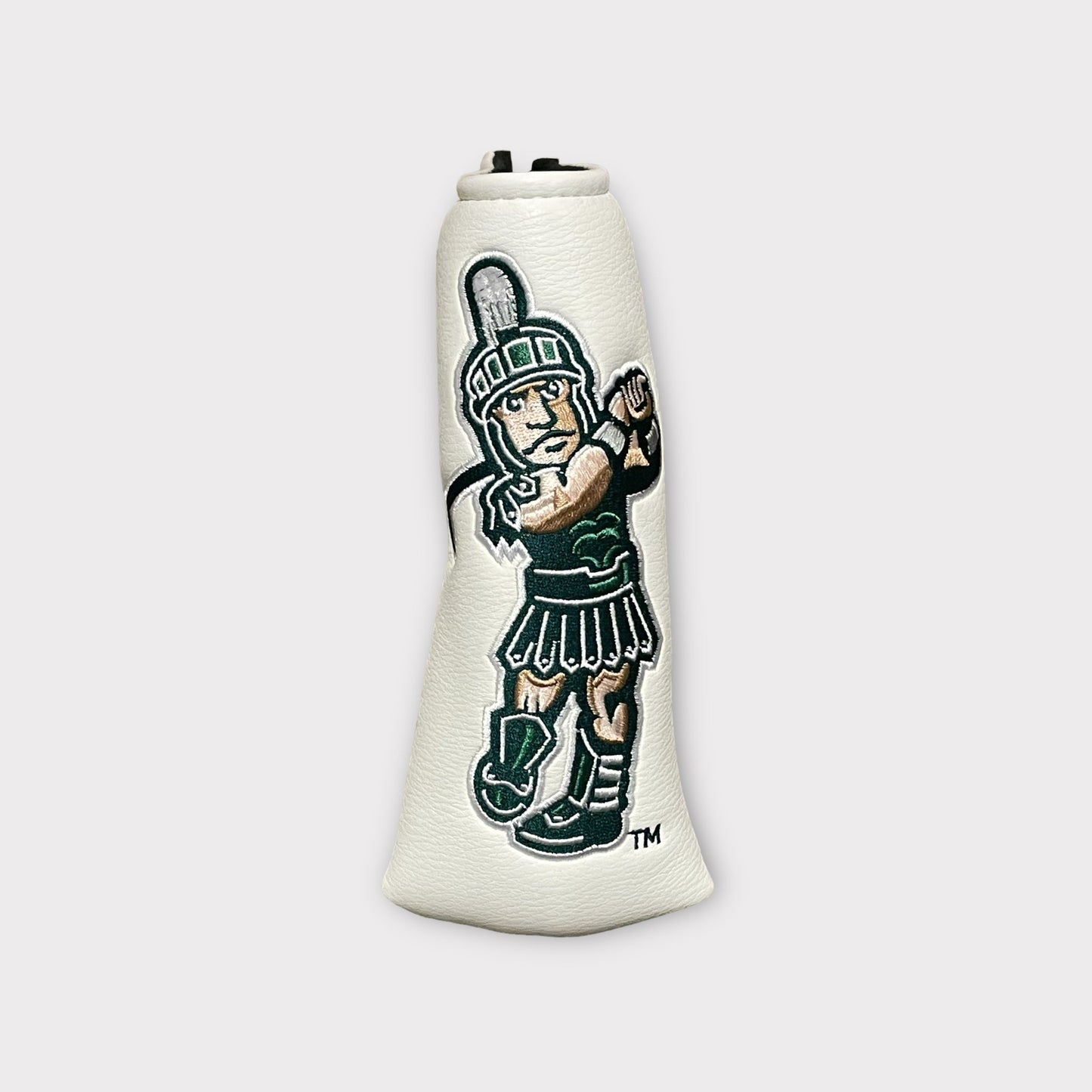 A white leather head cover featuring an embroidered golfing Sparty logo.