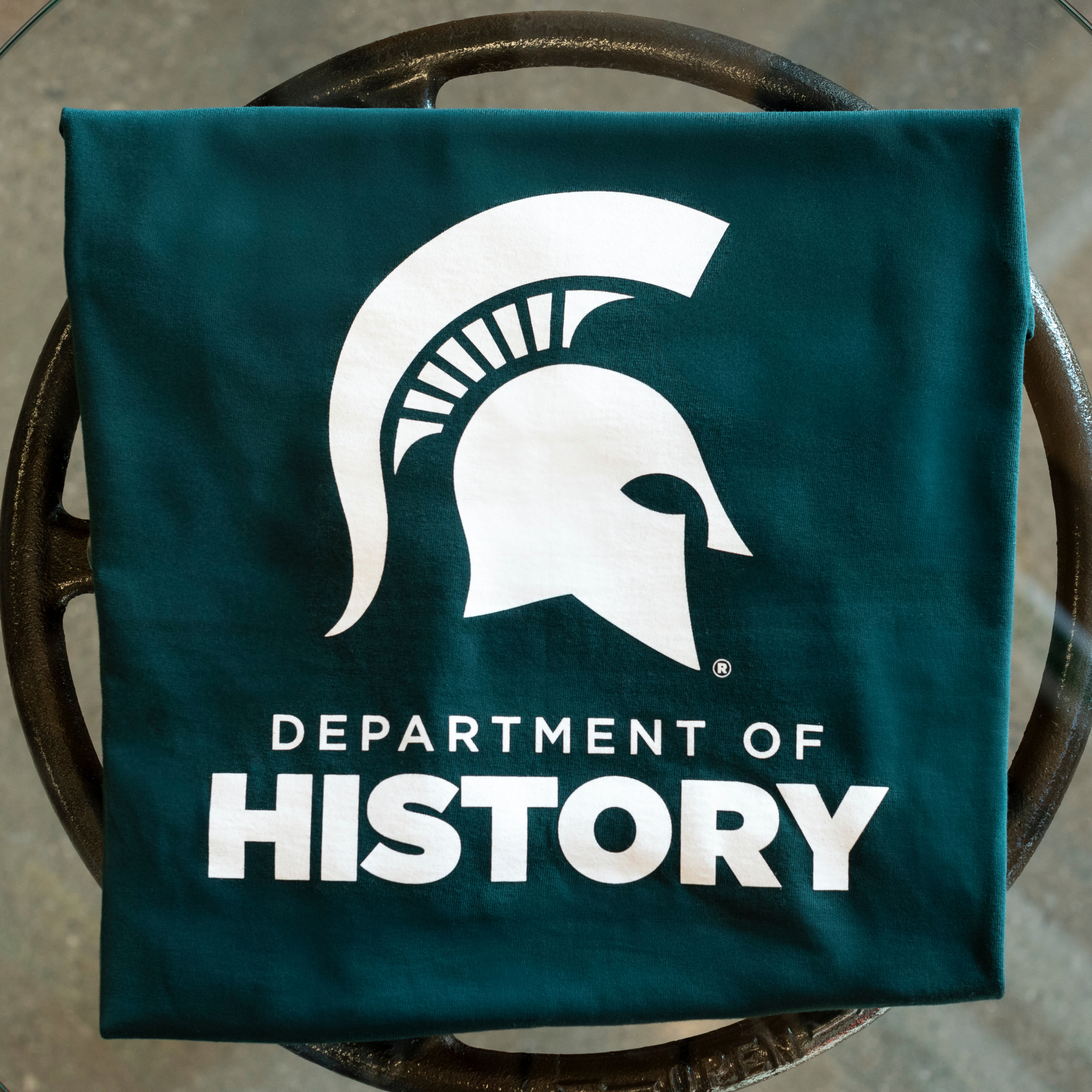 Forest green T-shirt featuring the Spartan Helmet above the text "Department of History" printed in white.