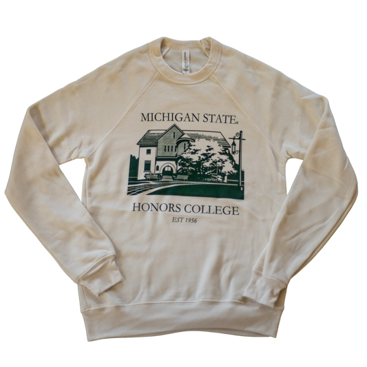 A natural/tan colored crewneck sweatshirt. On the torso of the sweatshirt in green is an image of the first MSU Honors College building. Around the image is the text "Michigan State Honors College est. 1956."