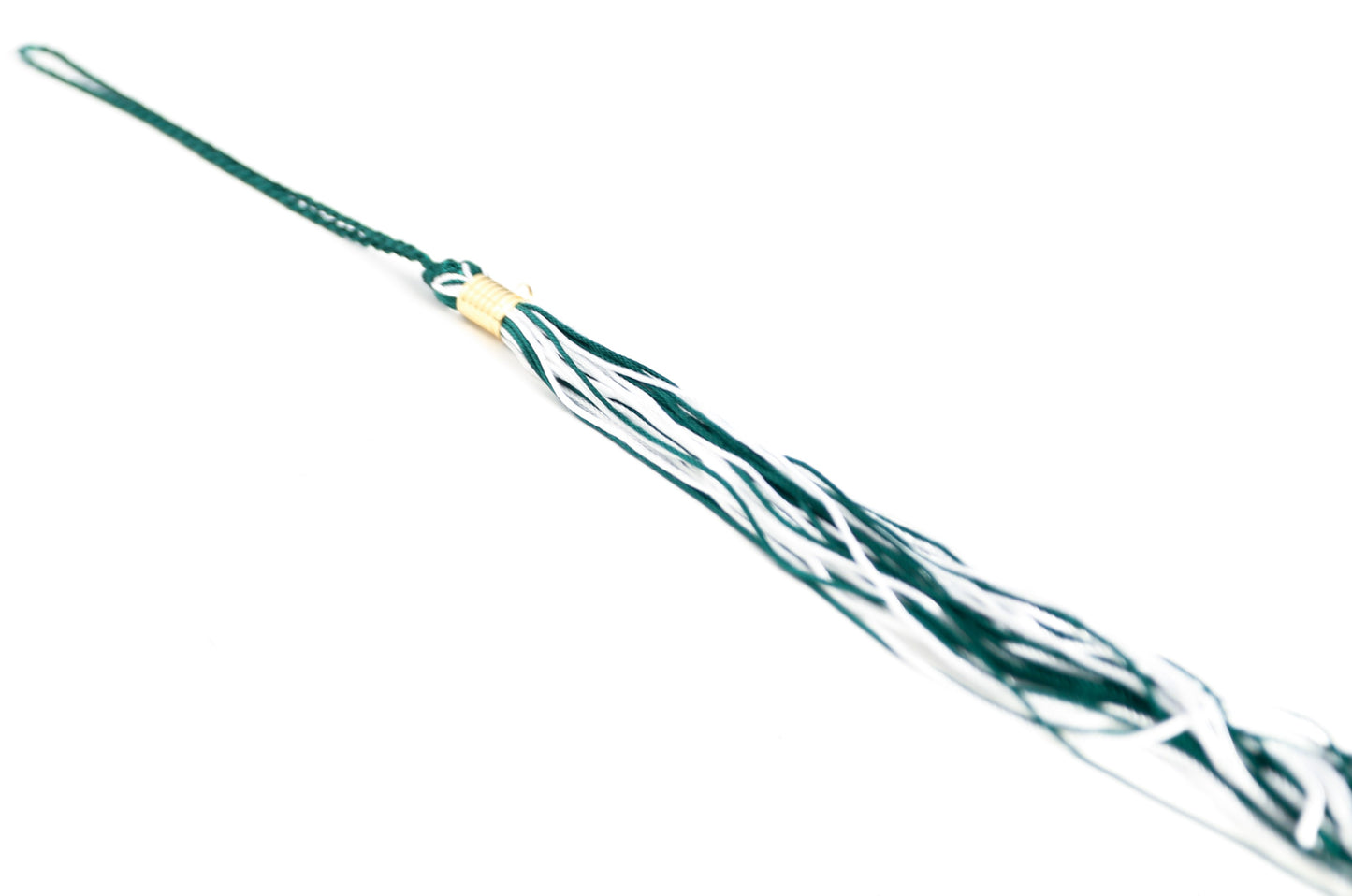 Green and white graduation souvenir tassel with gold clasp. Shown on a white background. 