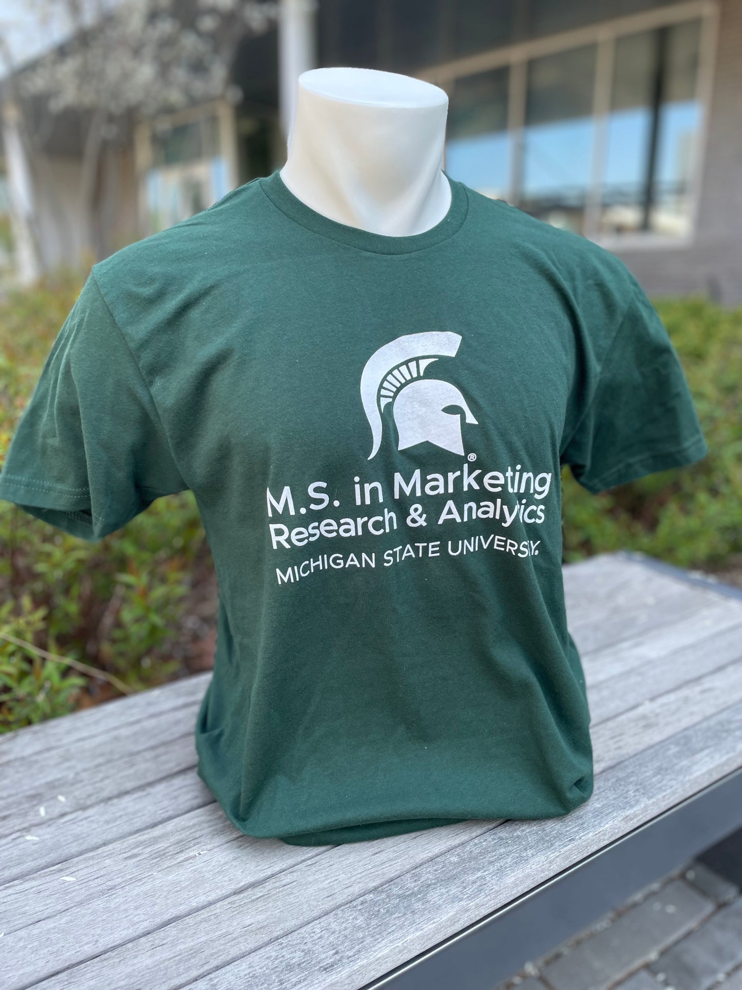 Green short sleeve T-shirt with the M.S. in Marketing Research & Analytics Michigan State University logo printed in white on the front.