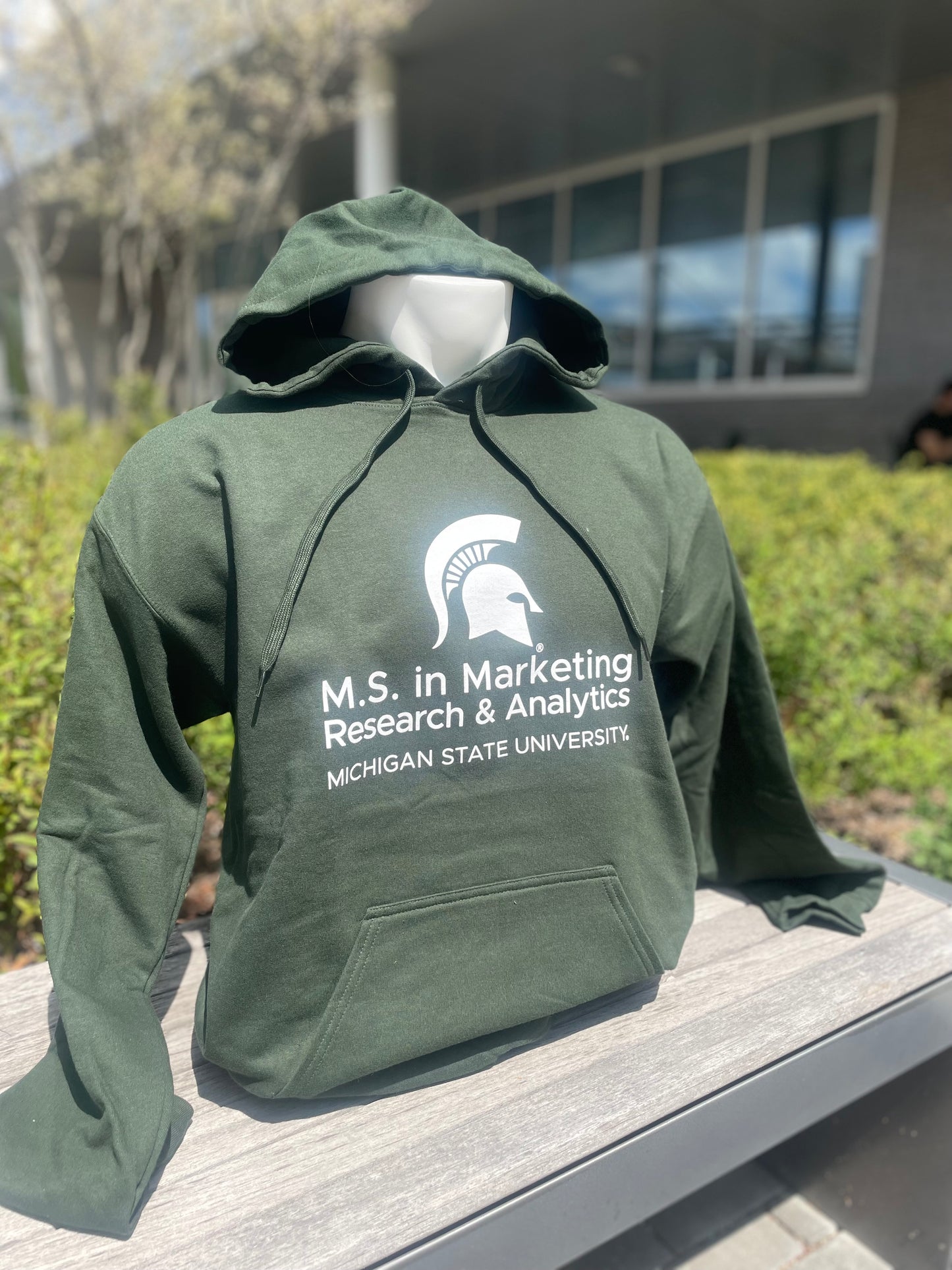 Green hoodie with  the M.S. in Marketing Research & Analytics Michigan State University logo printed in white on the front.