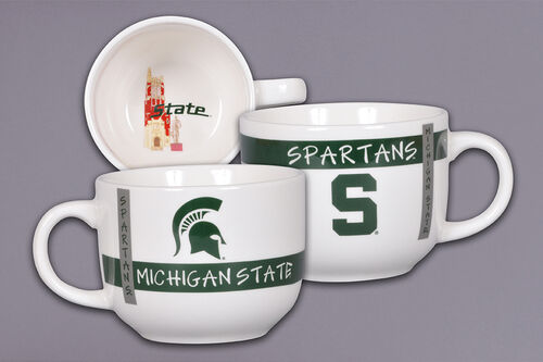 Three white ceramic mugs with Michigan State University branding. One features 'MICHIGAN STATE' and a Spartan helmet logo, another displays 'SPARTANS' with a large 'S', and the third shows a similar design. One mug has an illustration of a Beaumont Tower and partial 'State' text inside.