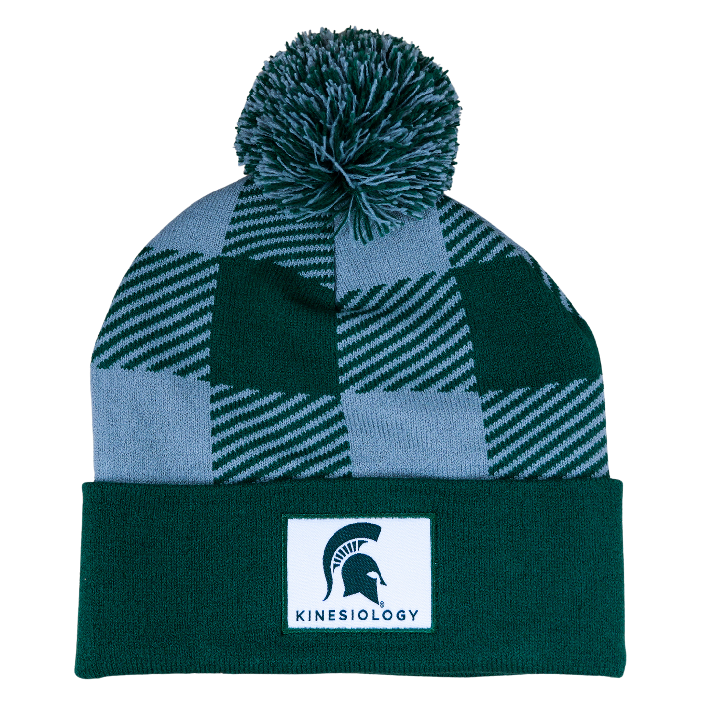 A green and gray plaid beanie with a matching pom. The cuff of the hat is green with a white sewn patch that features the Spartan Helmet logo and "Kinesiology" written in green.