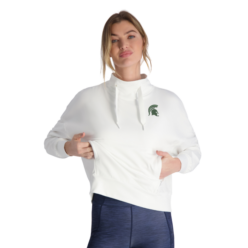 A woman wearing a white mock neck sweatshirt with a kangaroo pocket and a small green Spartan Helmet logo on the left side of the chest.