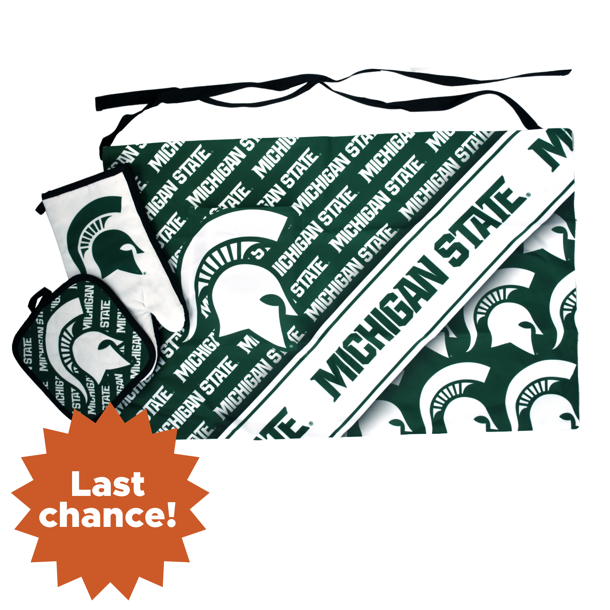 Green and white waist apron with various Michigan State graphics patterned across and a large pocket on the right thigh. A white oven mitt with a green Spartan helmet is layered on top, with a potholder patterned in green and white on top of that. In the lower left corner is an orange sunburst with the words "Last chance!"