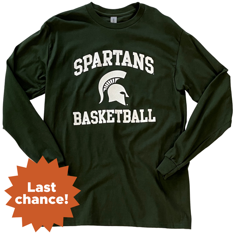 Forest green long-sleeve t-shirt with white printing centered on the torso. Around a Spartan helmet is two lines of block text: a curved line above reading Spartans and a straight line below reading Basketball. In the lower left corner is an orange sunburst with the words "Last chance!"