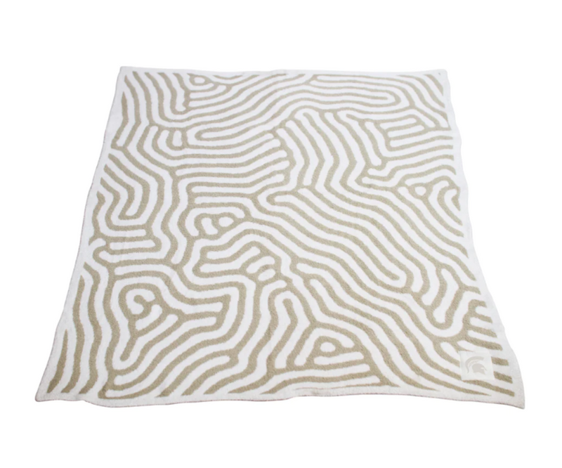 A white and beige patterned blanket with a Spartan helmet logo on the corner.