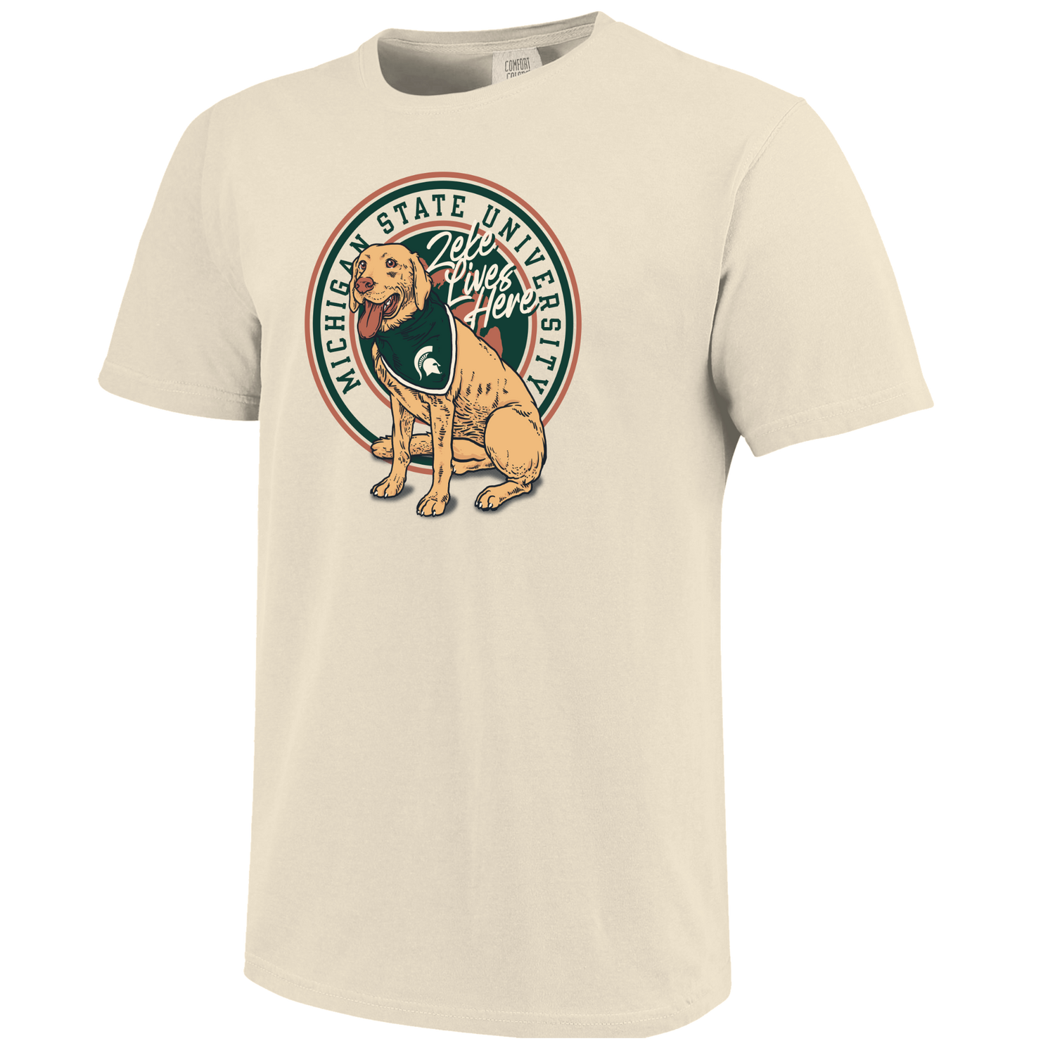 Beige T-shirt with Zeke the dog on the front, a curved "Michigan State University" wordmark, and text that reads "Zeke Lives Here."
