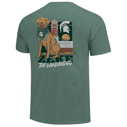Back of a green T-shirt with Zeke the dog on it and text that reads "Zeke the Wonderdog." Behind the dog graphic a MSU themed background. 