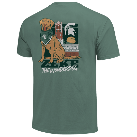Back of a green T-shirt with Zeke the dog on it and text that reads "Zeke the Wonderdog." Behind the dog graphic a MSU themed background. 