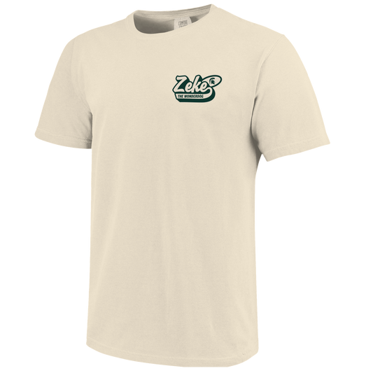 Front of a cream T-shirt with bubbled text that reads "Zeke the Wonderdog" on the upper left chest. 