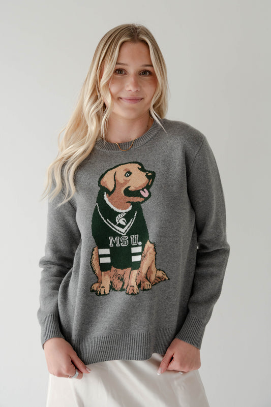 Young woman wearing a gray Michigan State University sweater featuring a large dog graphic in a green MSU jersey.