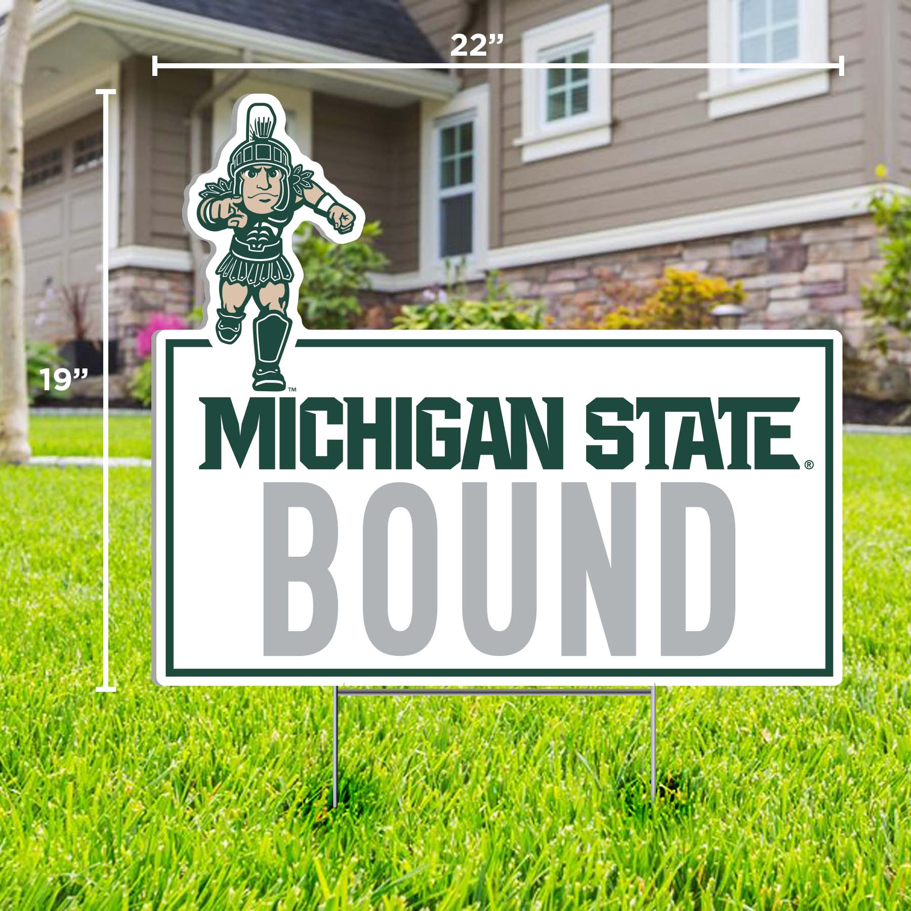A white rectangular lawn sign with 'MICHIGAN STATE BOUND' text in green and gray, and a running Sparty logo at the top. 