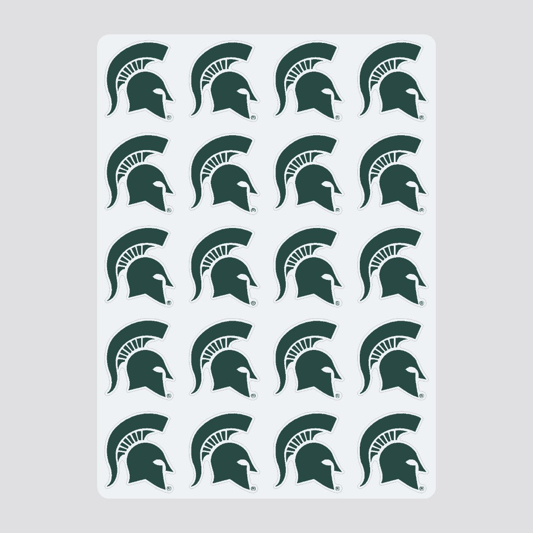 Sticker sheet labeled 'COLOR SHOCK MULTI-PURPOSE STICKERS' featuring 20 identical green Spartan helmet logos representing Michigan State University. The stickers are arranged in four rows of five.