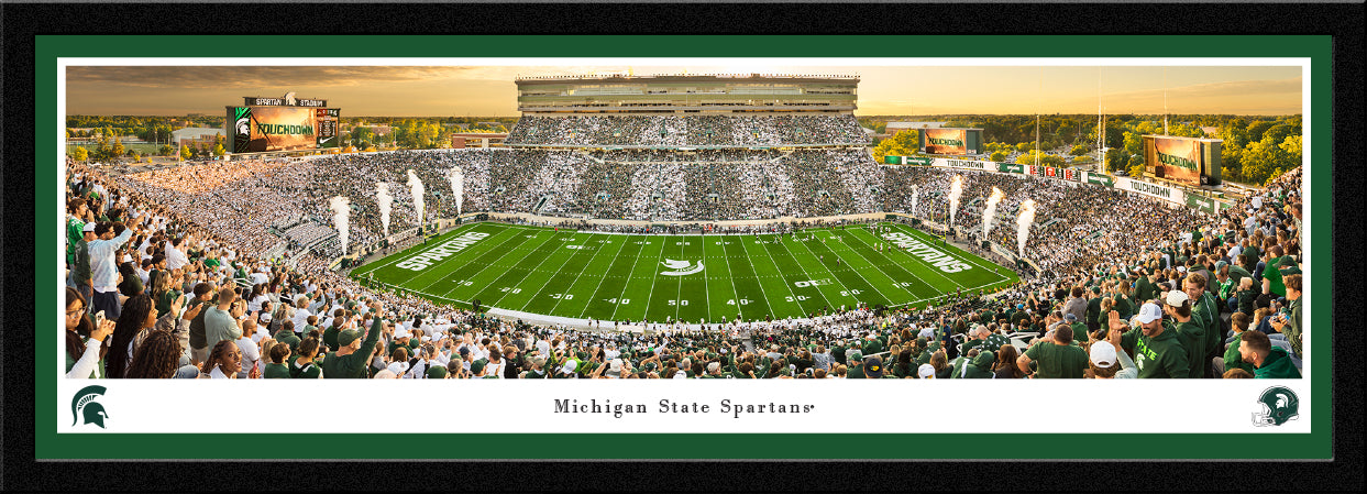 Panorama of the Michigan State Football team going head-to-head with the Western Michigan Broncos. The panorama has a green and white border and is framed with a black select frame. This product measures to 42 inches by 15.5 inches. 