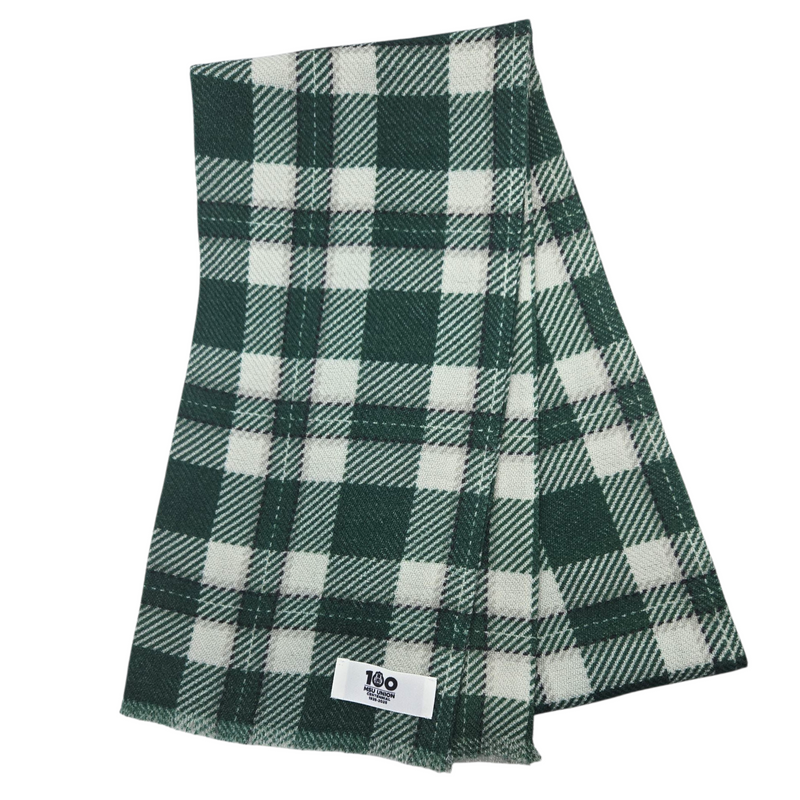 Green and white plaid wool scarf with a label on a white background
