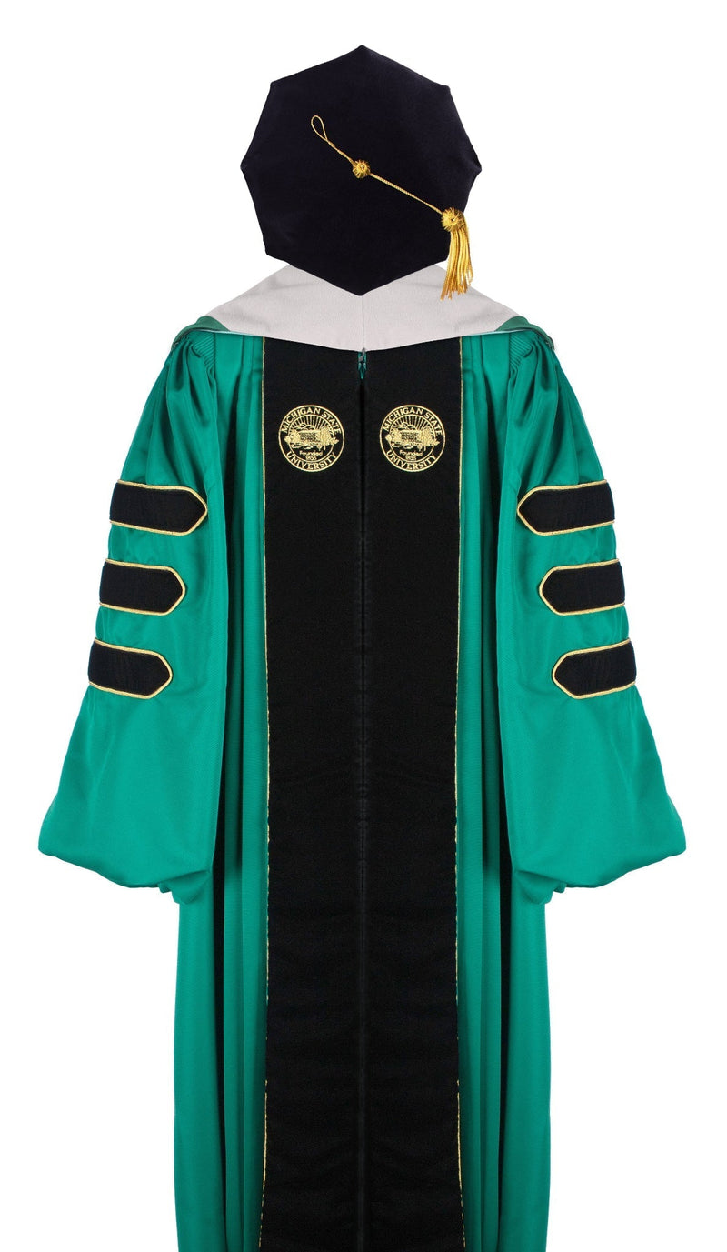 Green doctoral academic regalia gown with black velvet panels, gold piping, and three black velvet sleeve bars. Features two gold embroidered seals on the front and includes a black velvet tam with a gold tassel.