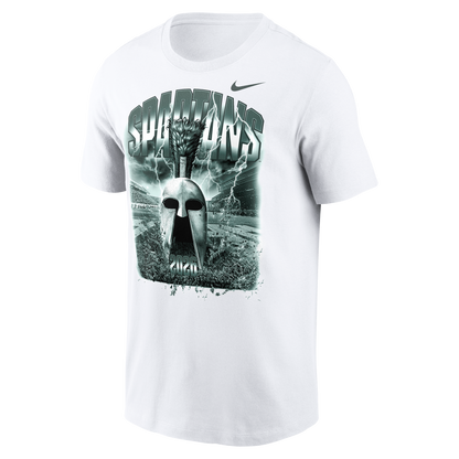 White Nike Michigan State Spartans T-shirt featuring a large green-toned graphic of a Spartan helmet centered on the chest. The design includes bold “SPARTANS” lettering, lightning effects, a stadium backdrop, and “2026” at the bottom of the artwork. A Nike Swoosh logo appears above the graphic on the upper right chest. Product shown on a light gray background.