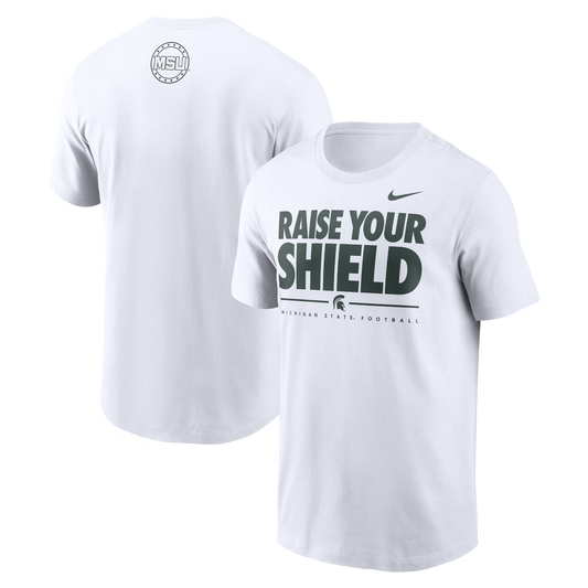 White T-shirt featuring 'RAISE YOUR SHIELD' in bold letters on the front, with 'MICHIGAN STATE FOOTBALL' and a Spartan helmet logo below. A small Nike logo is on the right shoulder. The back displays a circular logo with 'MSU' in the center and surrounding text.