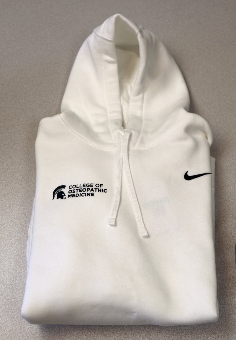 Front of white Nike hoodie with College of Osteopath Medicine logo embroidered on right front upper chest.  Nike embroidered logo in forest green on left side. 
