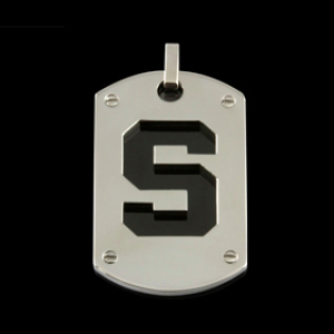 A stainless steel dog tag with a black enamel block S in the center and rivets in all four corners.
