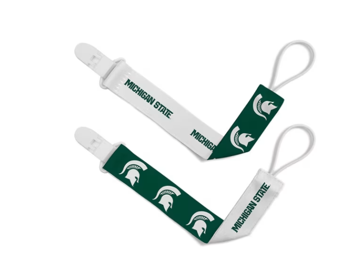 A pair of green and white Michigan State pacifier clips.