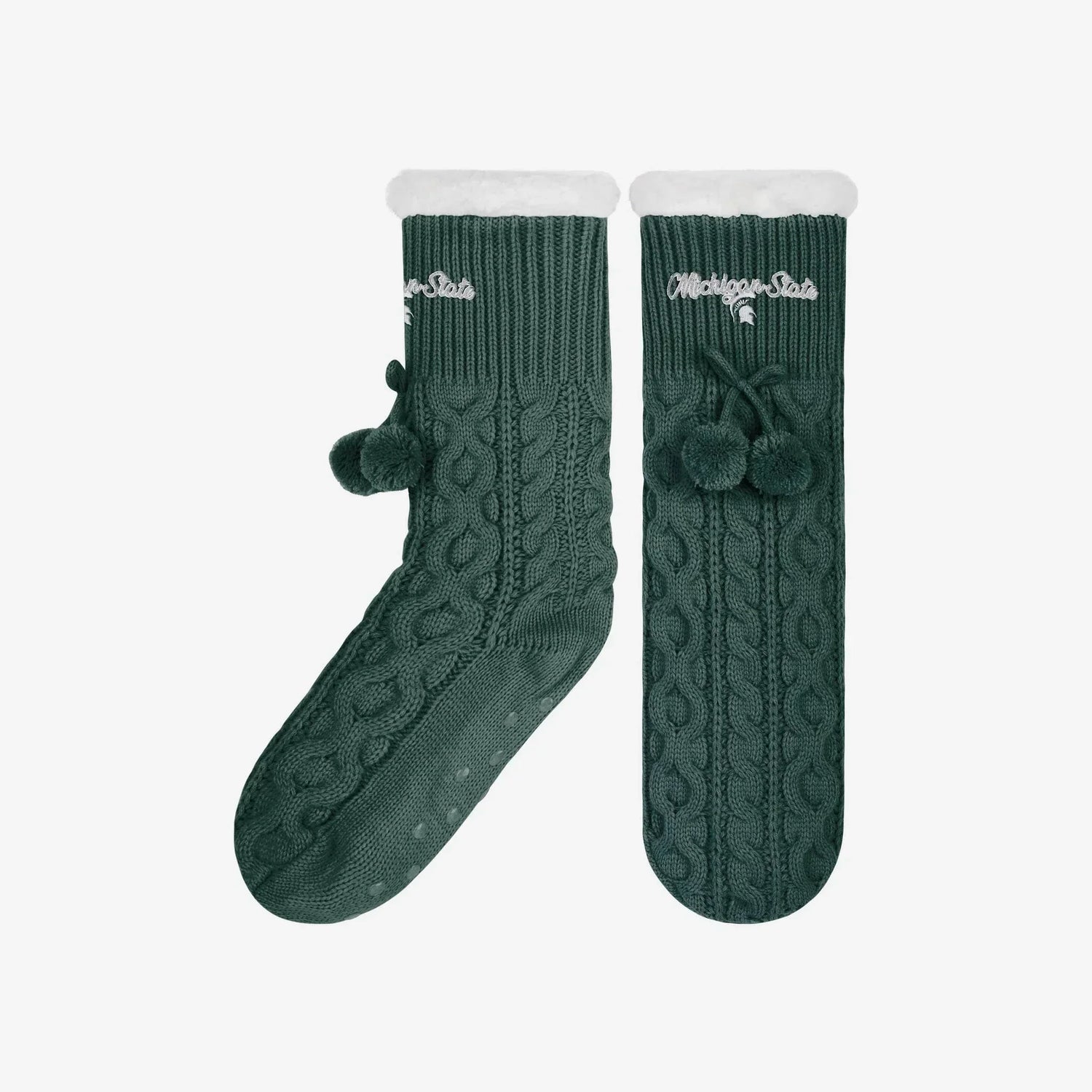Forest green cable knit slipper socks with an embroidered white "Michigan State" wordmark and a white Spartan helmet logo below it on the top of the socks. The socks have gripper bottoms, green ties and pom poms, and a white plush hem. 