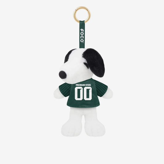 Plush Snoopy bag charm wearing a green Michigan State football jersey with white “Michigan State” text and the number “00” on the front. The white and black Snoopy character features soft plush fabric, black ears, and a black nose, attached to a green FOCO-branded strap with a gold-tone keyring.